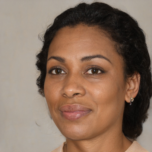 Joyful black young-adult female with medium  brown hair and brown eyes
