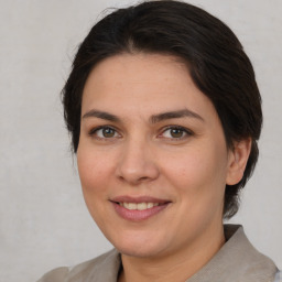 Joyful white adult female with medium  brown hair and brown eyes