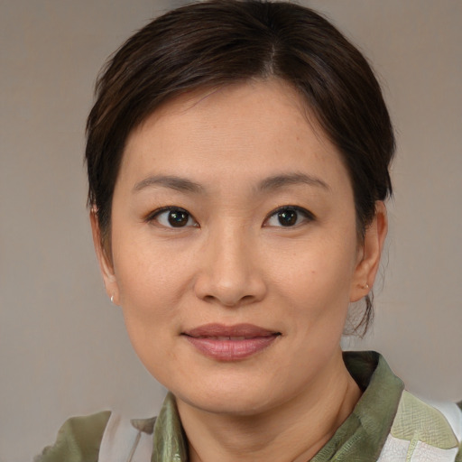 Joyful asian young-adult female with medium  brown hair and brown eyes