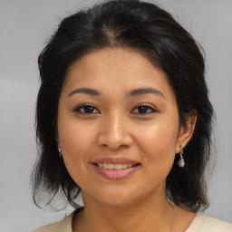 Joyful asian young-adult female with medium  brown hair and brown eyes