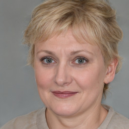 Joyful white adult female with medium  brown hair and blue eyes