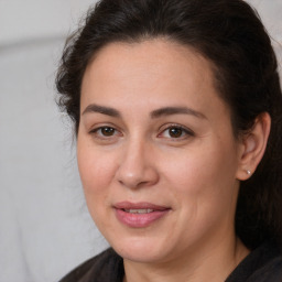 Joyful white adult female with long  brown hair and brown eyes