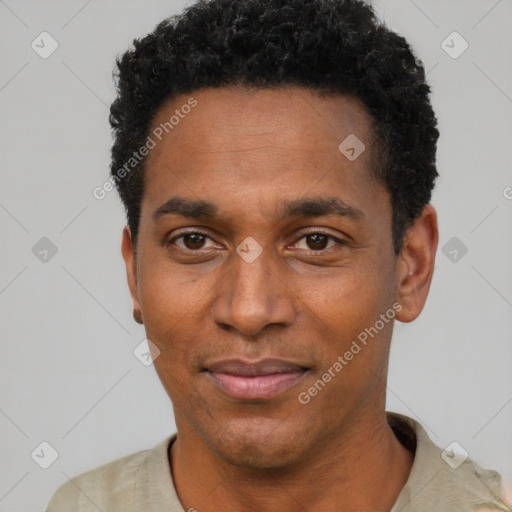 Joyful black adult male with short  black hair and brown eyes
