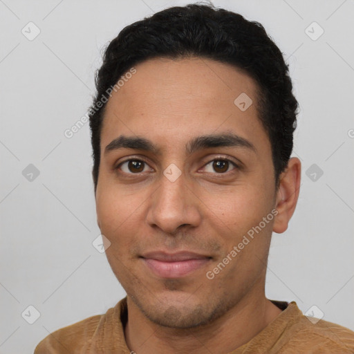 Joyful latino young-adult male with short  black hair and brown eyes