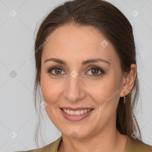 Joyful white adult female with long  brown hair and brown eyes