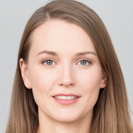 Joyful white young-adult female with long  brown hair and grey eyes