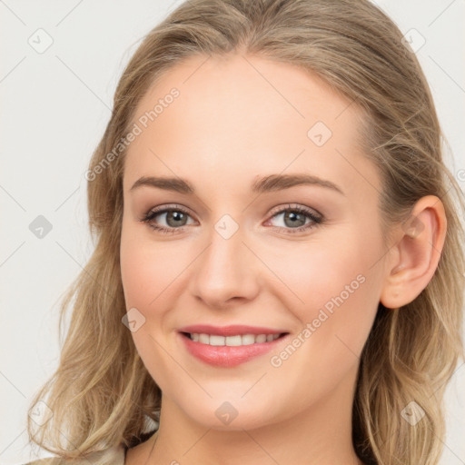 Joyful white young-adult female with long  brown hair and blue eyes