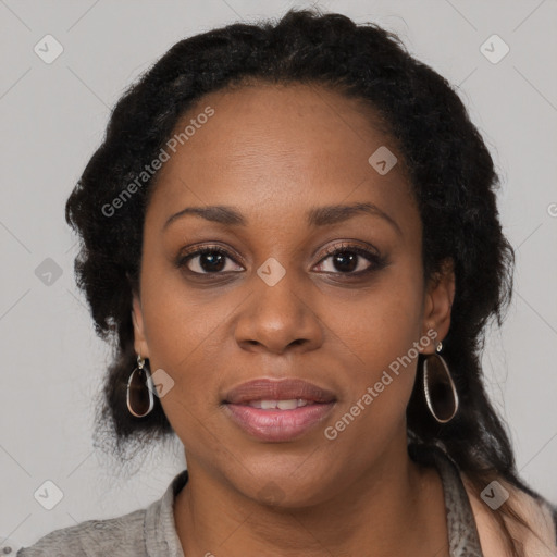 Joyful black young-adult female with long  black hair and brown eyes