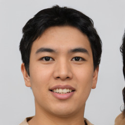 Joyful asian young-adult male with short  black hair and brown eyes