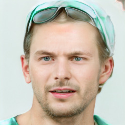 Joyful white young-adult male with short  brown hair and blue eyes