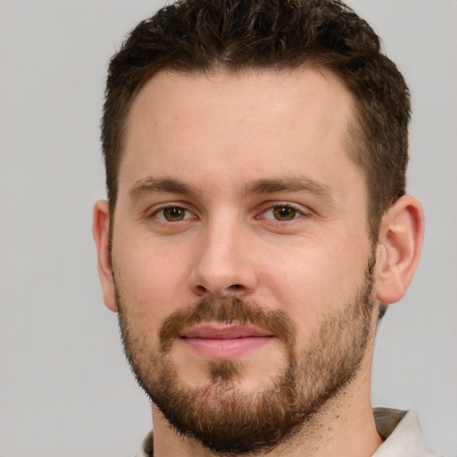 Joyful white young-adult male with short  brown hair and brown eyes