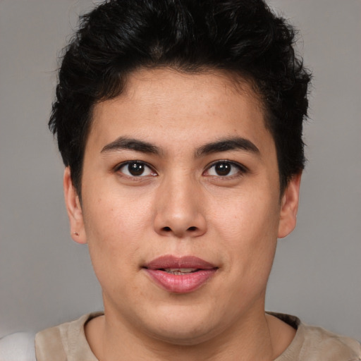 Joyful latino young-adult male with short  brown hair and brown eyes