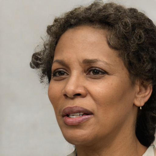 Joyful black adult female with short  brown hair and brown eyes