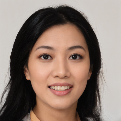 Joyful latino young-adult female with long  black hair and brown eyes