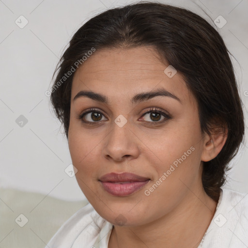 Joyful latino young-adult female with medium  brown hair and brown eyes