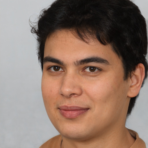 Joyful latino young-adult male with short  brown hair and brown eyes