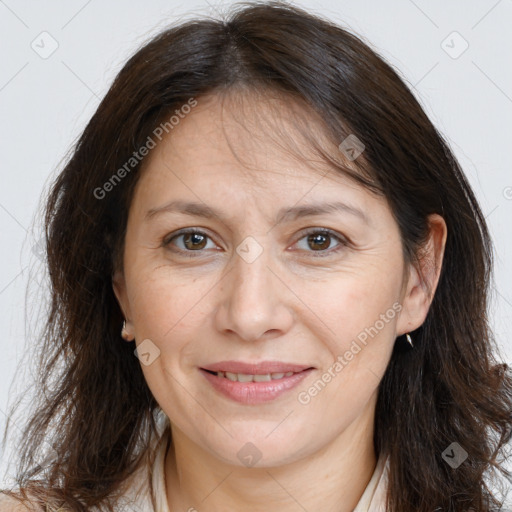 Joyful white adult female with long  brown hair and brown eyes