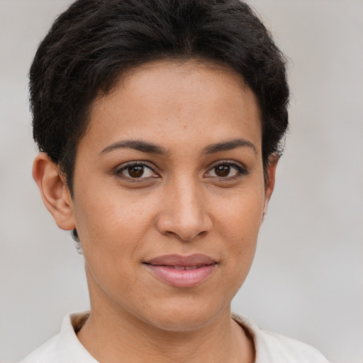 Joyful latino young-adult female with short  brown hair and brown eyes