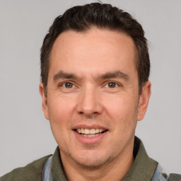 Joyful white adult male with short  brown hair and grey eyes