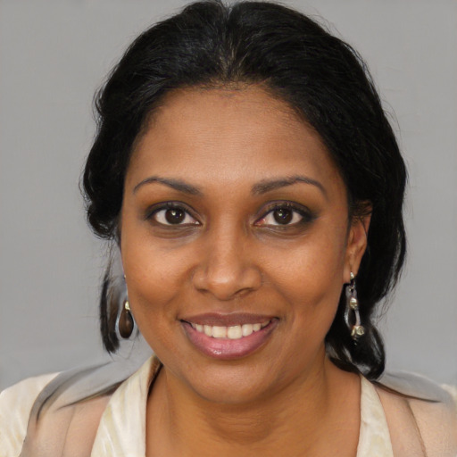 Joyful black young-adult female with medium  brown hair and brown eyes