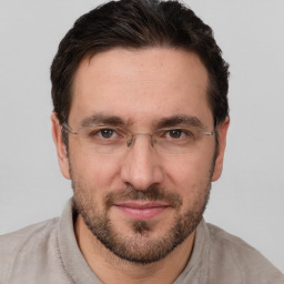 Joyful white adult male with short  brown hair and brown eyes