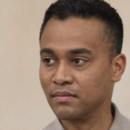 Neutral black young-adult male with short  black hair and brown eyes