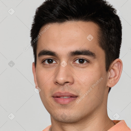 Joyful white young-adult male with short  black hair and brown eyes