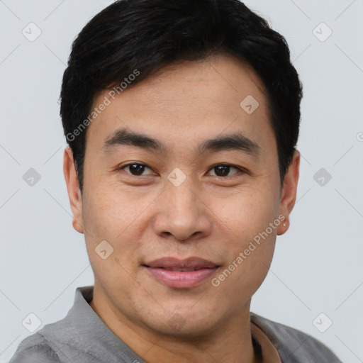 Joyful asian young-adult male with short  black hair and brown eyes