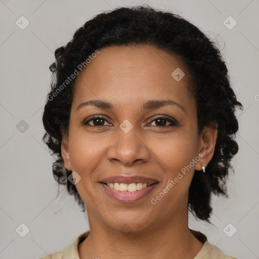 Joyful black adult female with medium  brown hair and brown eyes