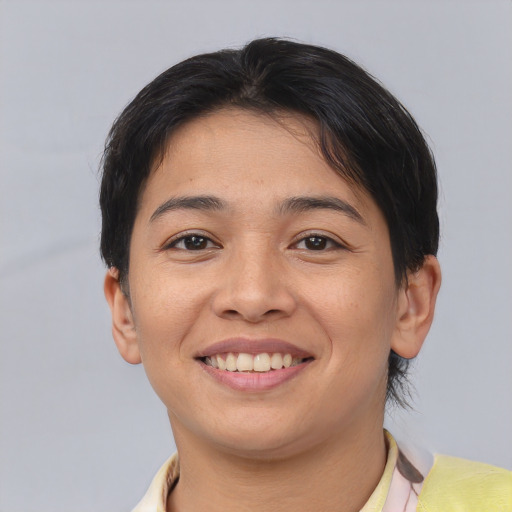 Joyful asian young-adult female with short  brown hair and brown eyes