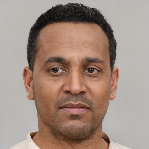 Neutral latino adult male with short  black hair and brown eyes