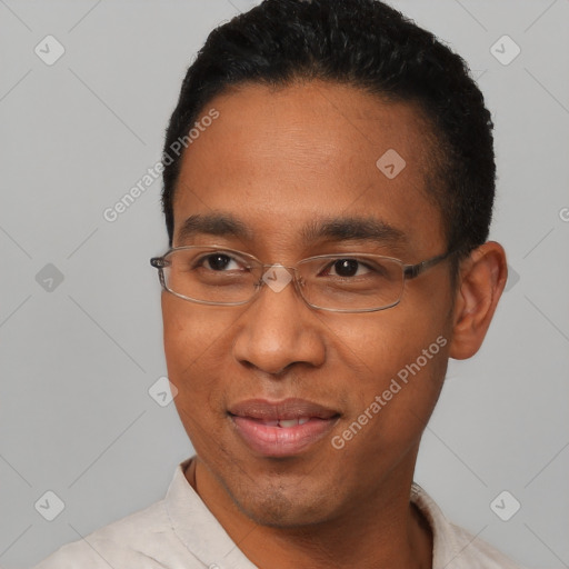 Joyful black young-adult male with short  black hair and brown eyes