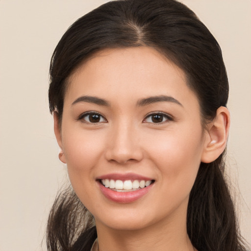 Joyful white young-adult female with long  brown hair and brown eyes