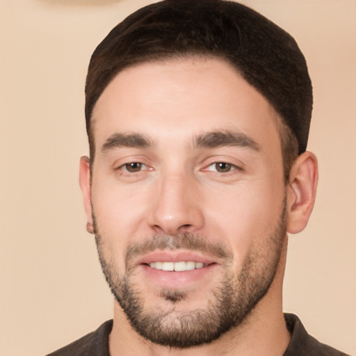 Joyful white young-adult male with short  black hair and brown eyes