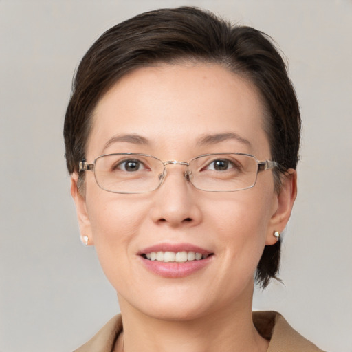 Joyful white adult female with medium  brown hair and grey eyes