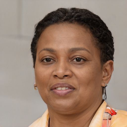 Joyful black adult female with short  brown hair and brown eyes
