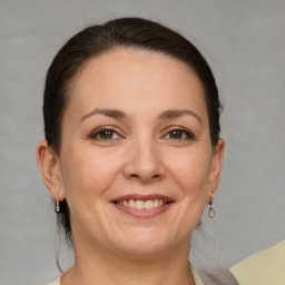 Joyful white adult female with short  brown hair and brown eyes