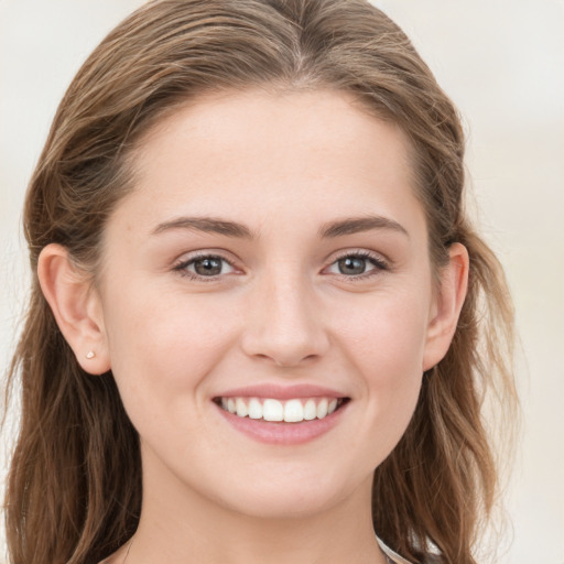 Joyful white young-adult female with long  brown hair and grey eyes