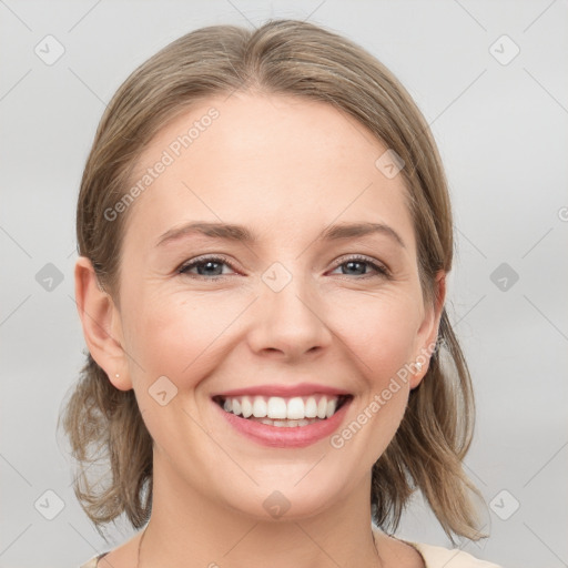 Joyful white young-adult female with medium  brown hair and grey eyes