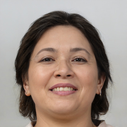 Joyful white adult female with medium  brown hair and brown eyes