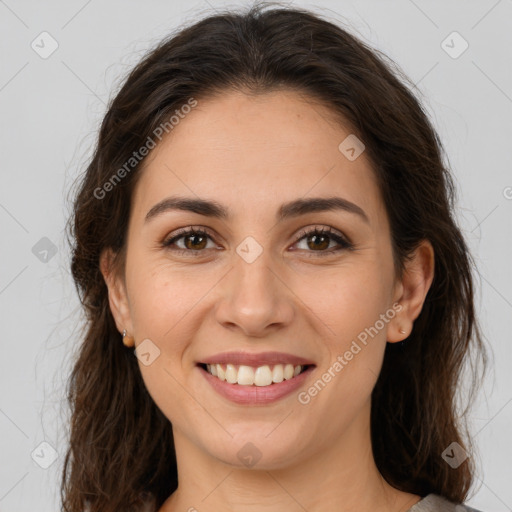 Joyful white young-adult female with long  brown hair and brown eyes