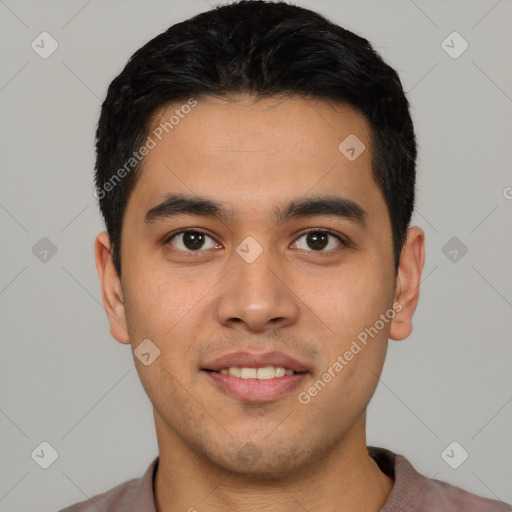 Joyful latino young-adult male with short  black hair and brown eyes