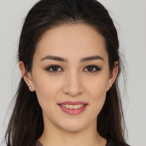Joyful white young-adult female with long  brown hair and brown eyes