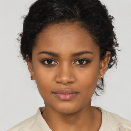 Joyful black young-adult female with short  brown hair and brown eyes