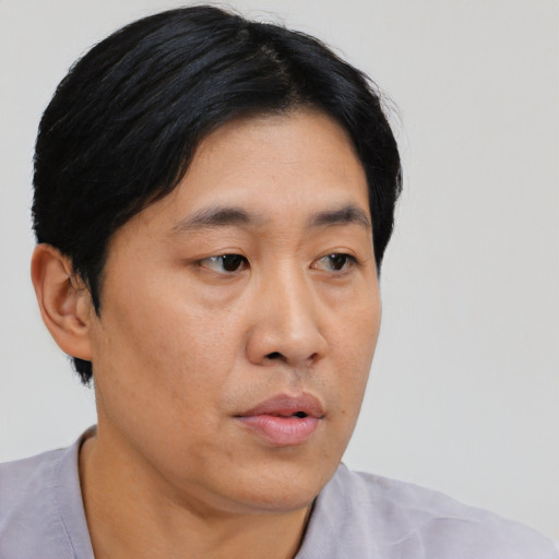 Neutral asian adult male with short  black hair and brown eyes