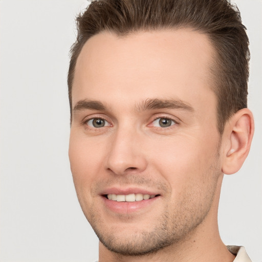 Joyful white young-adult male with short  brown hair and brown eyes