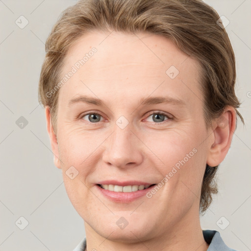 Joyful white young-adult female with short  brown hair and grey eyes