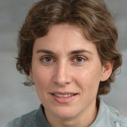 Joyful white adult female with medium  brown hair and green eyes