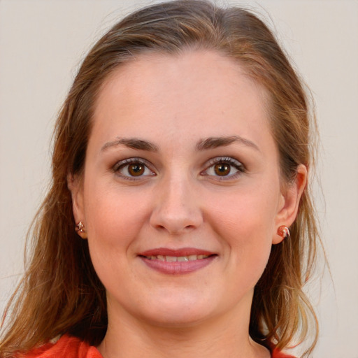 Joyful white young-adult female with long  brown hair and blue eyes