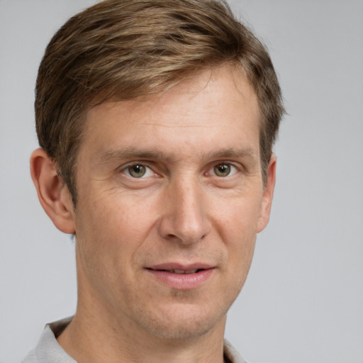 Joyful white adult male with short  brown hair and grey eyes